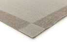 Close-up of a textured gray rug corner on a white background