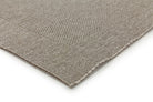 Close-up of a textured gray rug corner on a white background
