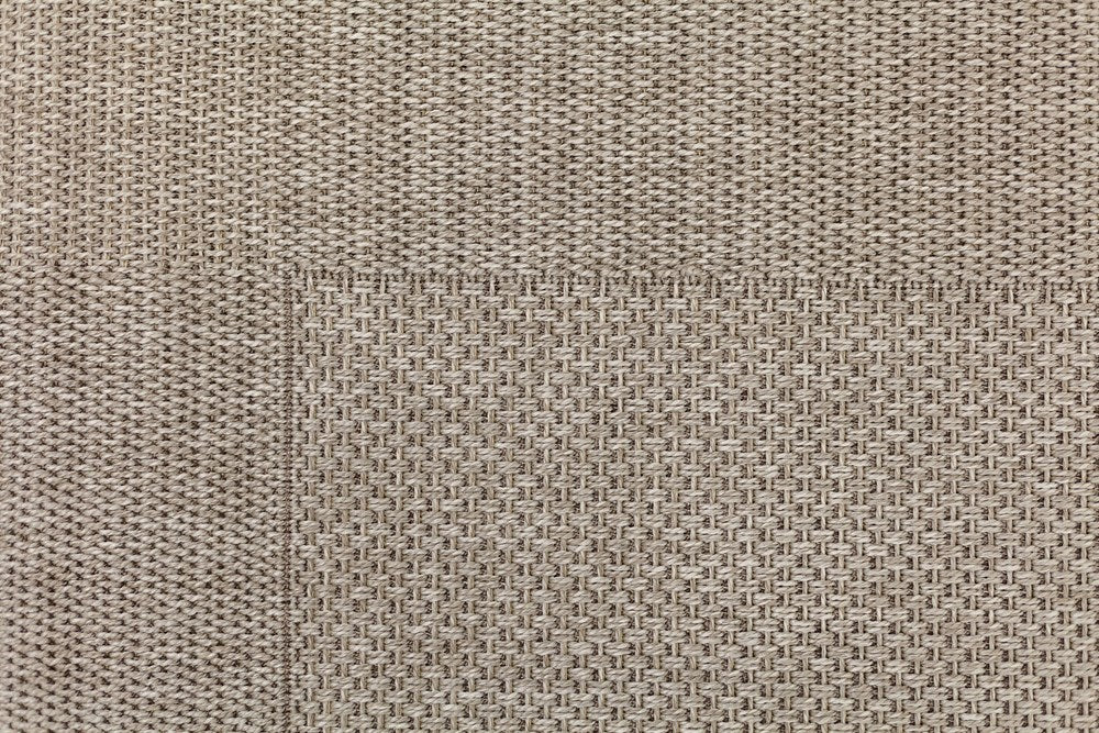 Close-up of a textured beige fabric surface
