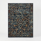 A rectangular area rug with a distressed traditional floral pattern in dark navy blue, teal, and beige, shown flat against a light gray background.