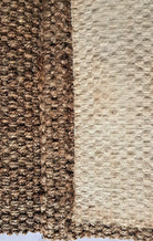 Close-up of brown and beige textured carpet samples.