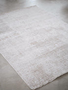 White textured rug on a concrete floor