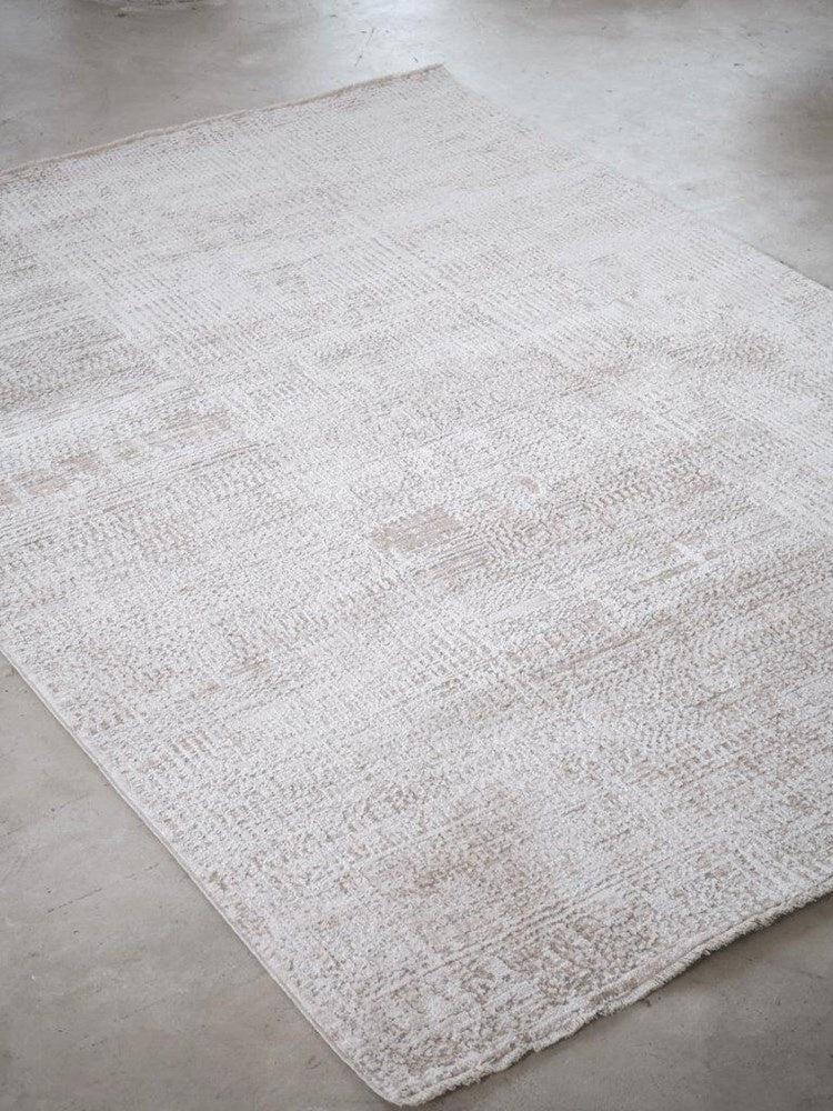 White textured rug on a concrete floor