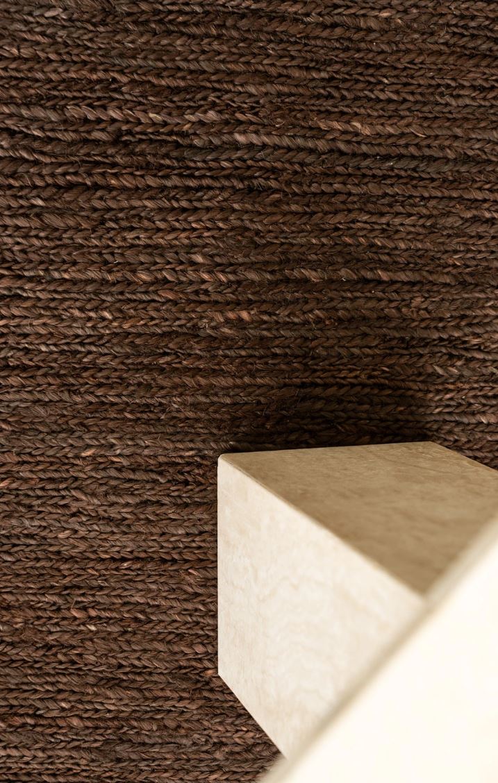 Textured brown wall with a white rectangular object