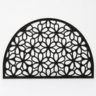 A black arched doormat with an intricate geometric floral cutout pattern, shown against a plain white background.