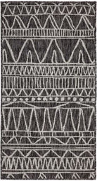 Patterned rug with geometric design on a black background