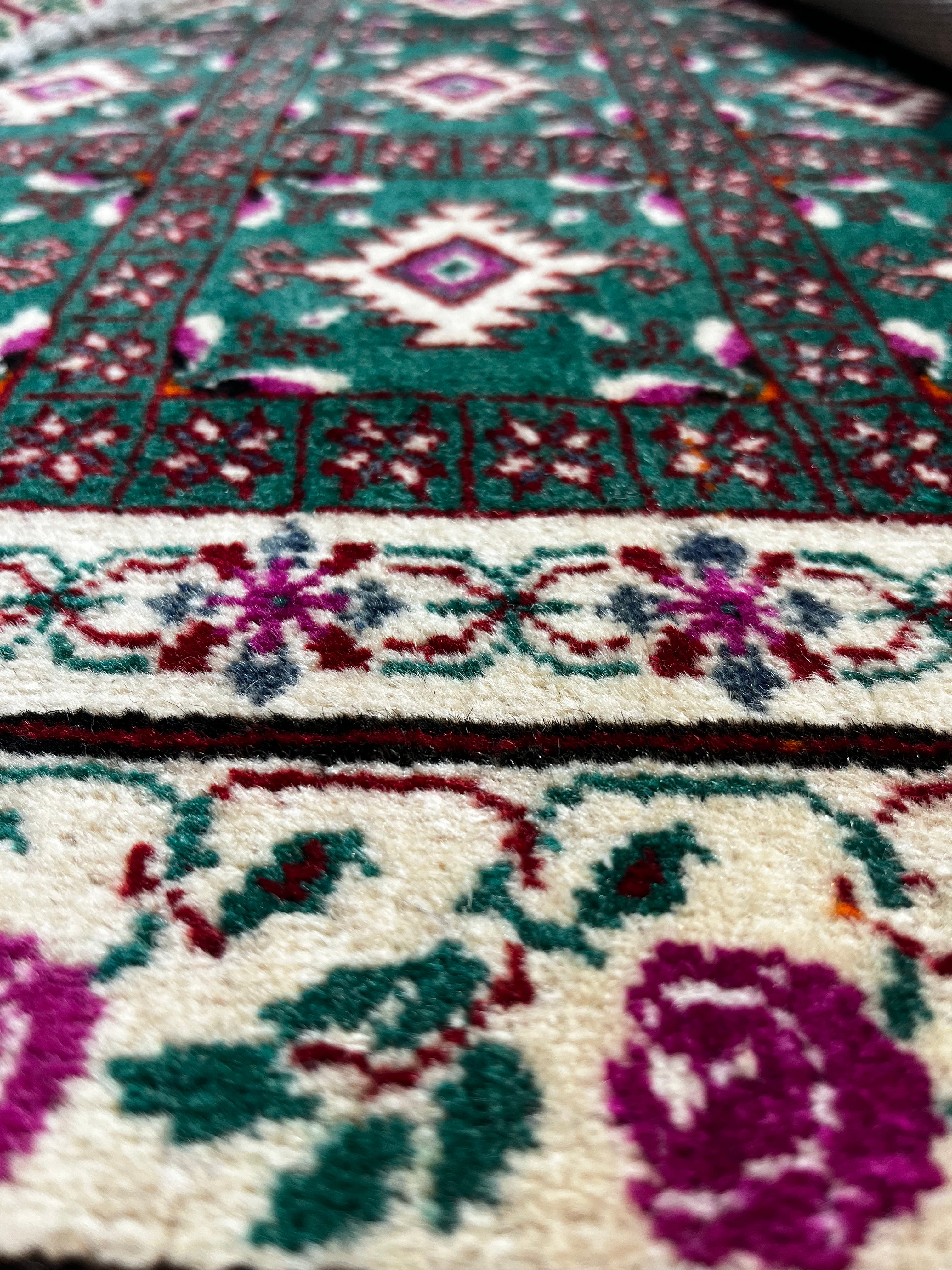 Close-up of a patterned rug with floral designs.