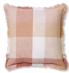 A square throw pillow with a soft plaid pattern in dusty pink, beige, white, and muted orange, finished with fringed edges.
