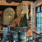 Decorative hares and wicker baskets in a store setting with large hanging lights.