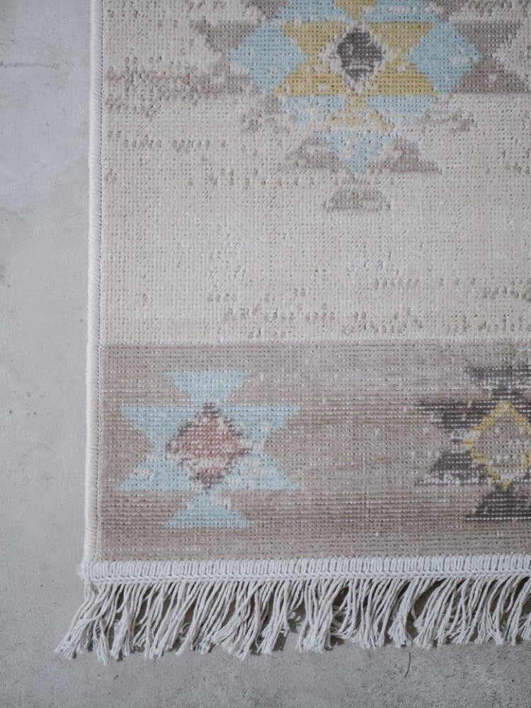 Textured area rug with geometric pattern on a concrete floor