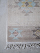 Textured area rug with geometric pattern on a concrete floor