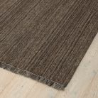 Brown textured rug on a light wood floor