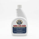 Fabric and rug guard bottle with Definitive Edge logo on a white background