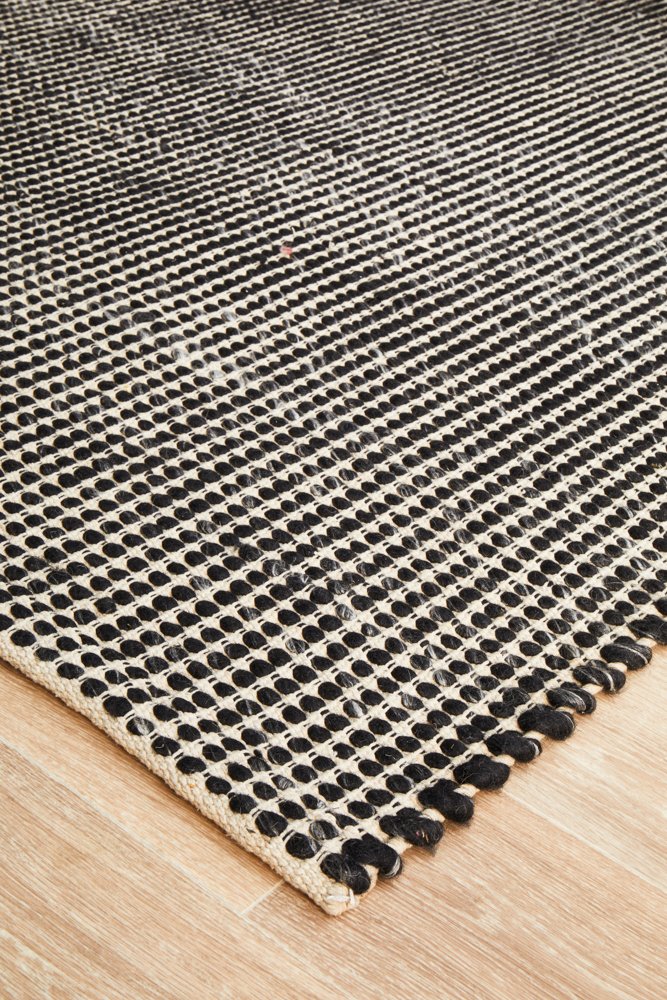 black and white rug on timber flooring
