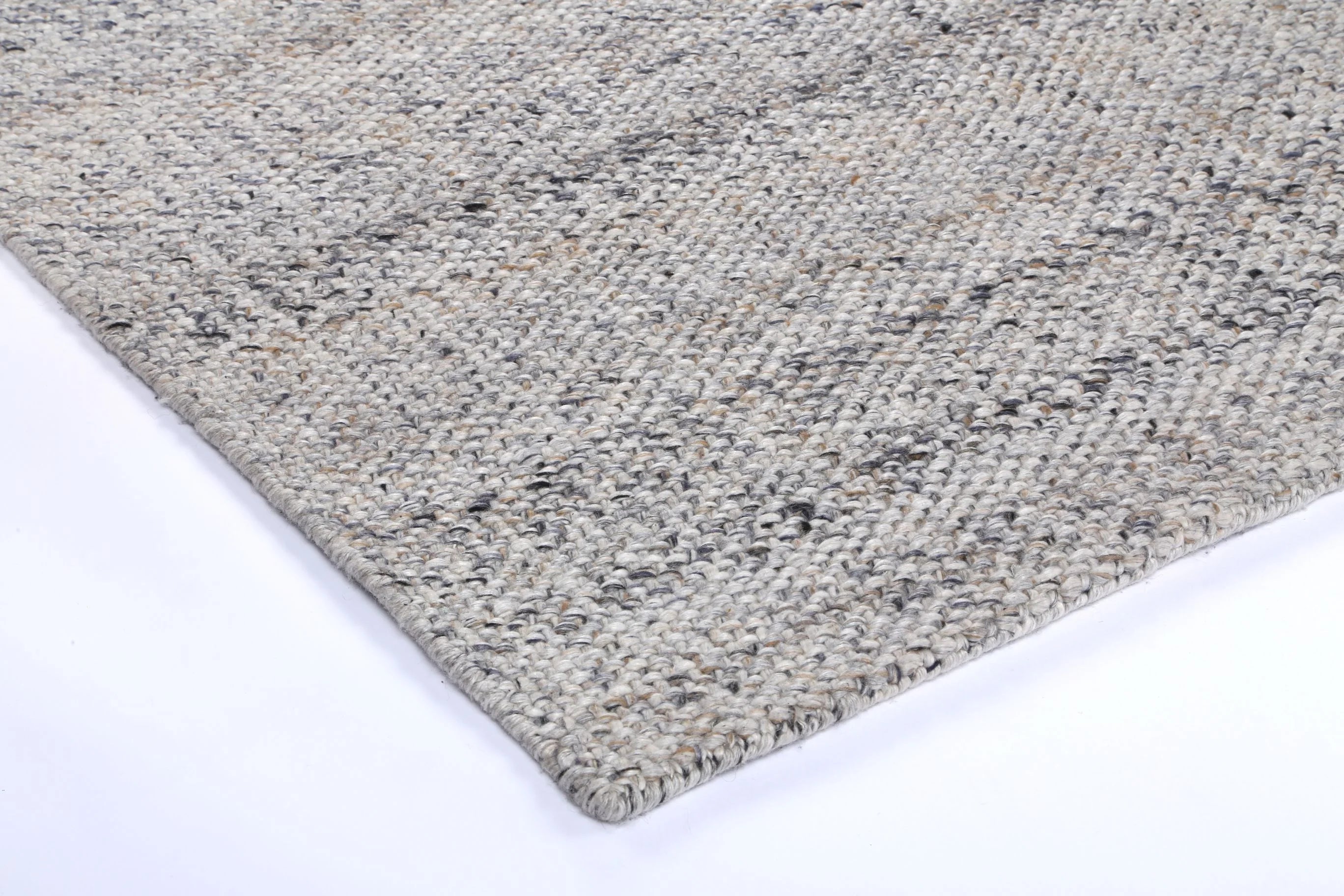 Detail shot of the Salar Gunj Collection Anthra rug edge, displaying the fine craftsmanship and durable binding.