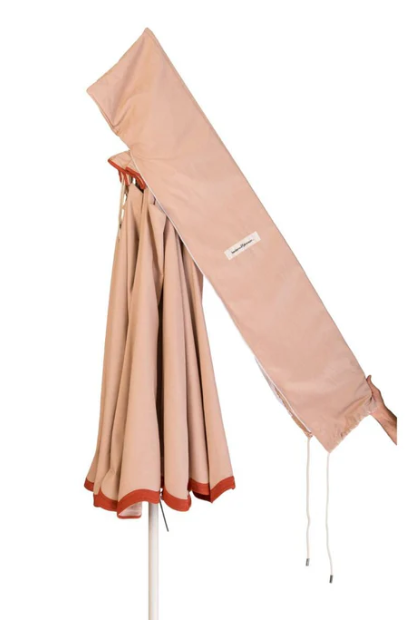 Beige outdoor umbrella with a matching carrying case on a white background