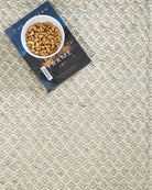 Book titled 'The Frame' on a textured rug