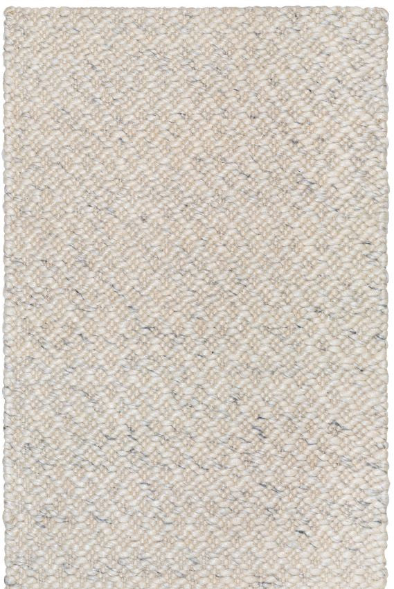 Textured beige rug with a subtle pattern