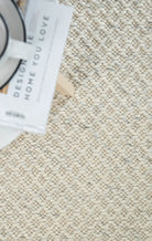 Textured cream rug with a close-up of woven pattern
