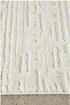 Textured beige rug on a concrete floor