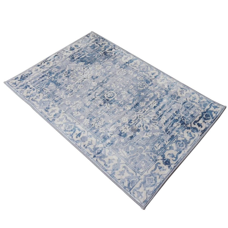 Blue and white patterned rug on a white background