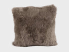Fluffy brown sheepskin pillow on a white background