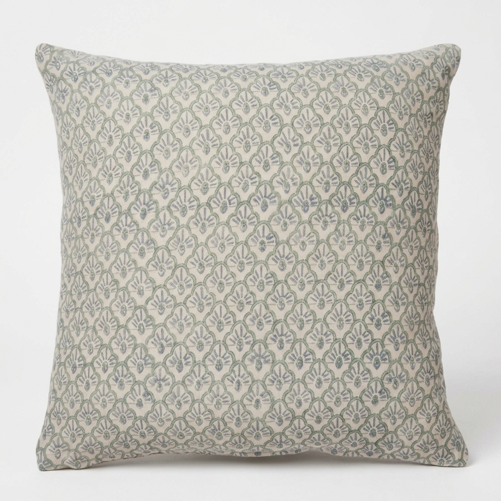 A square throw pillow featuring a repeating block-printed damask pattern in muted sage green and light gray on a warm off-white background.