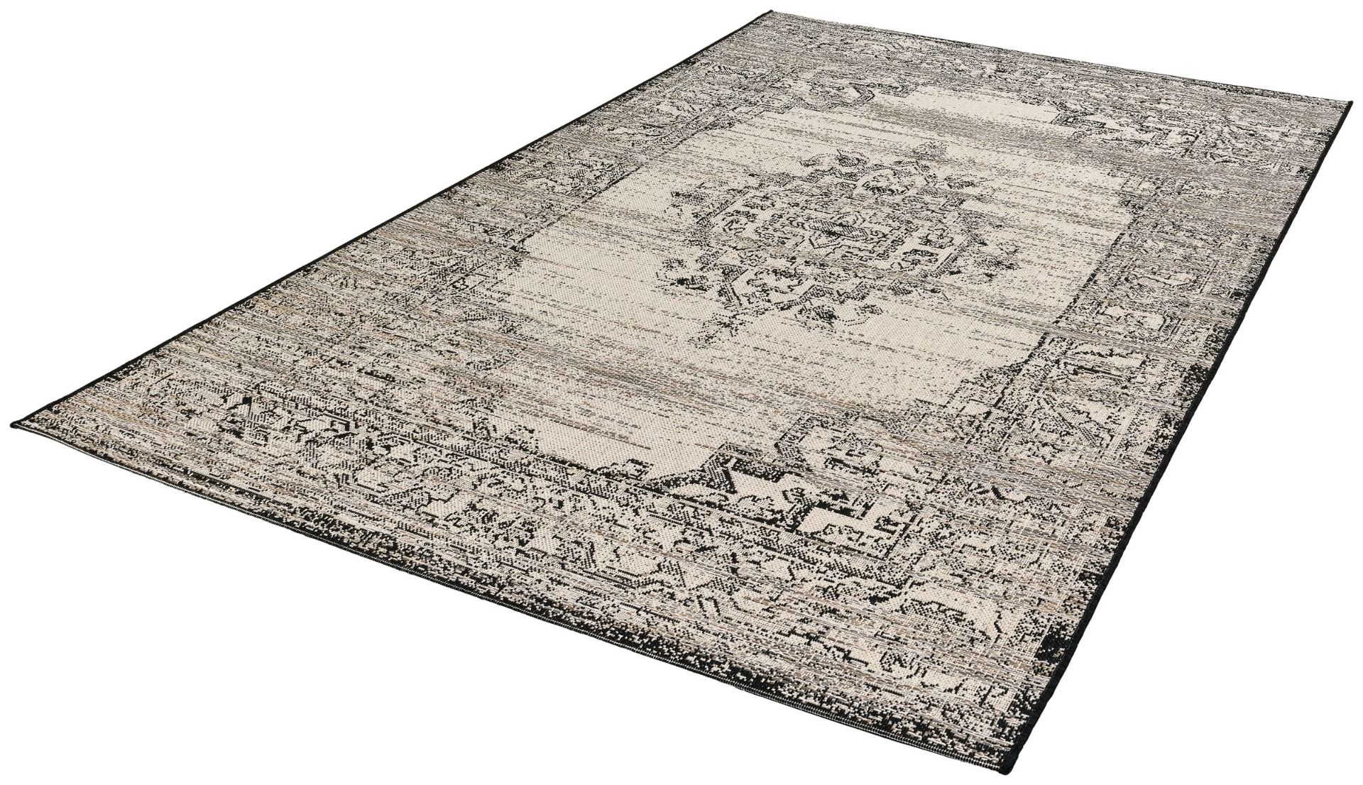 Decorative rug with intricate patterns on a plain background