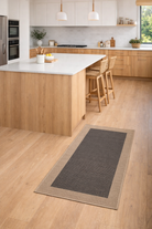 Kitchen with a gray rug on wooden floor