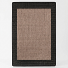 A rectangular woven rug with a wide black border and a central tan-brown textured field, shown flat against a light gray background.
