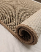 Rolled-up beige carpet on a light background