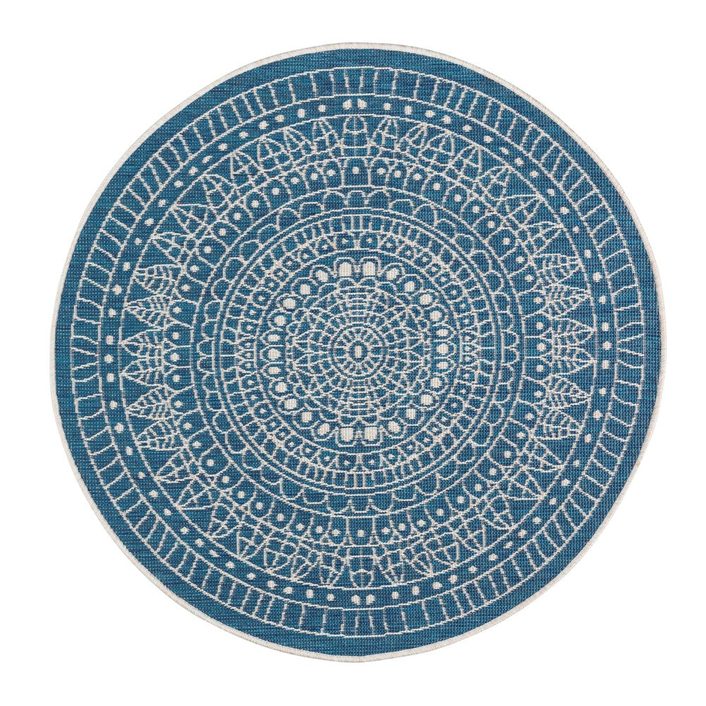 Round blue and white patterned rug on a white background
