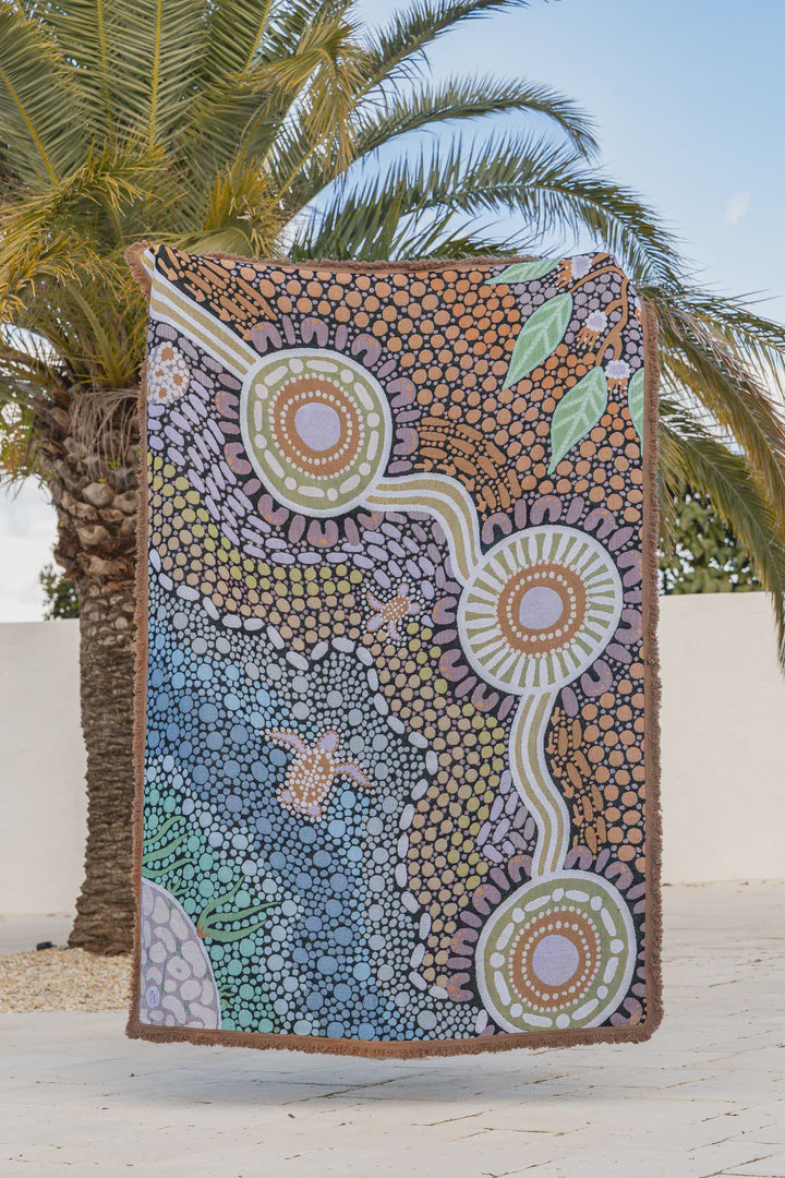 Colorful abstract design towel with palm tree in the background