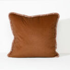 A square brown throw pillow with a fringed edge, shown against a plain white background.