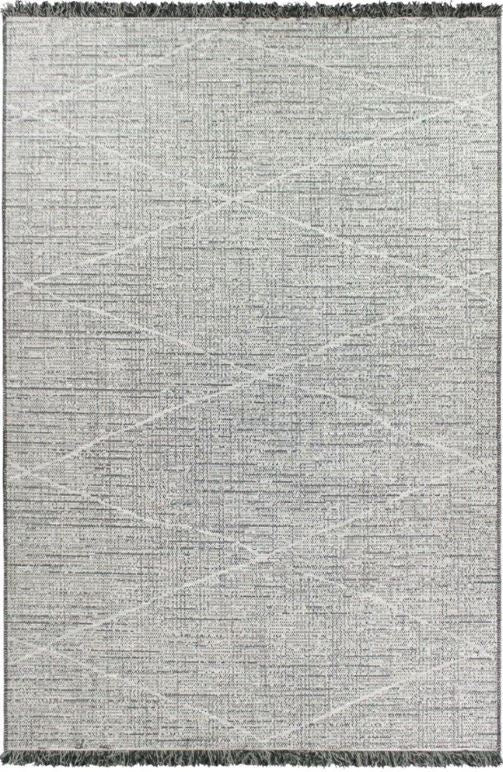 Gray area rug with geometric pattern and tassels on a plain background