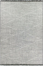 Gray area rug with geometric pattern and tassels on a plain background