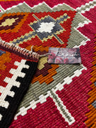 Close-up of a Turkish bath and home product label on a patterned rug.