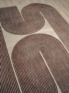 Rug with brown abstract pattern on a beige background