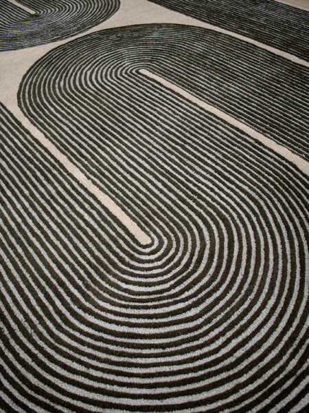 Close-up of a black and white patterned rug with concentric circles.