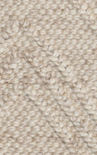 Close-up of beige knitted fabric texture.