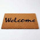 Doormat with 'Welcome' text on a white background