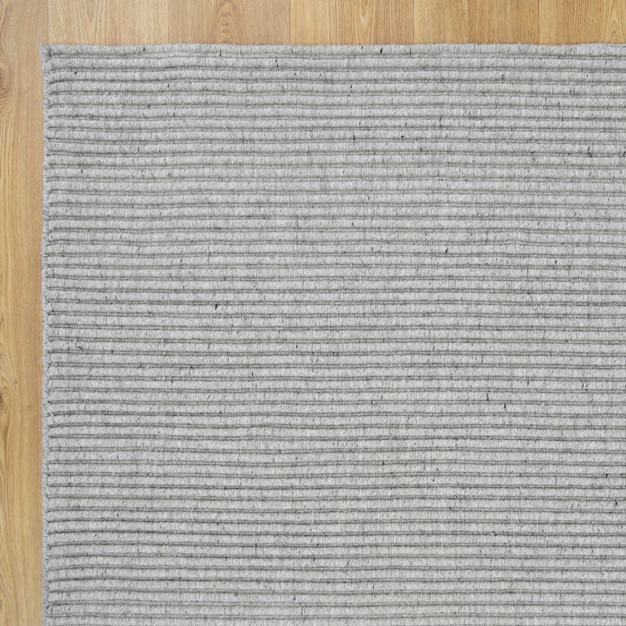 Detailed close-up of the Zalia Grey Rug's intricate handloomed texture, highlighting the quality of its wool blend.