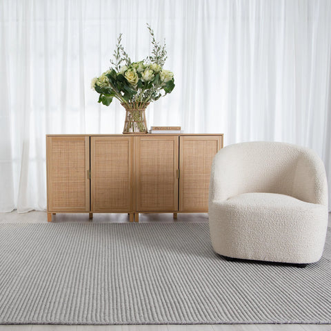 Zalia Handloom Grey Rug placed in a contemporary room setting, demonstrating its modern style and luxurious feel.