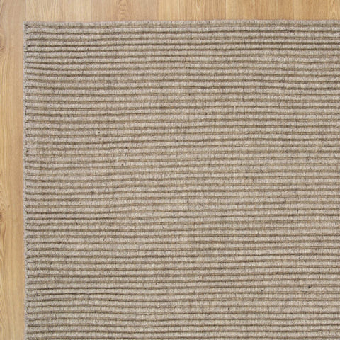 Detailed close-up of the Zalia Putty Rug's texture, highlighting the quality of its wool blend and intricate handloom weave.