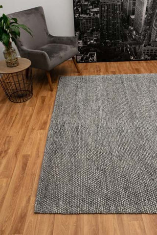 Elegant Avenue Rug displayed in a modern living room, showcasing its grey and natural tones that beautifully complement contemporary home decor.