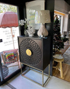 Decorative cabinet with intricate design in a home setting