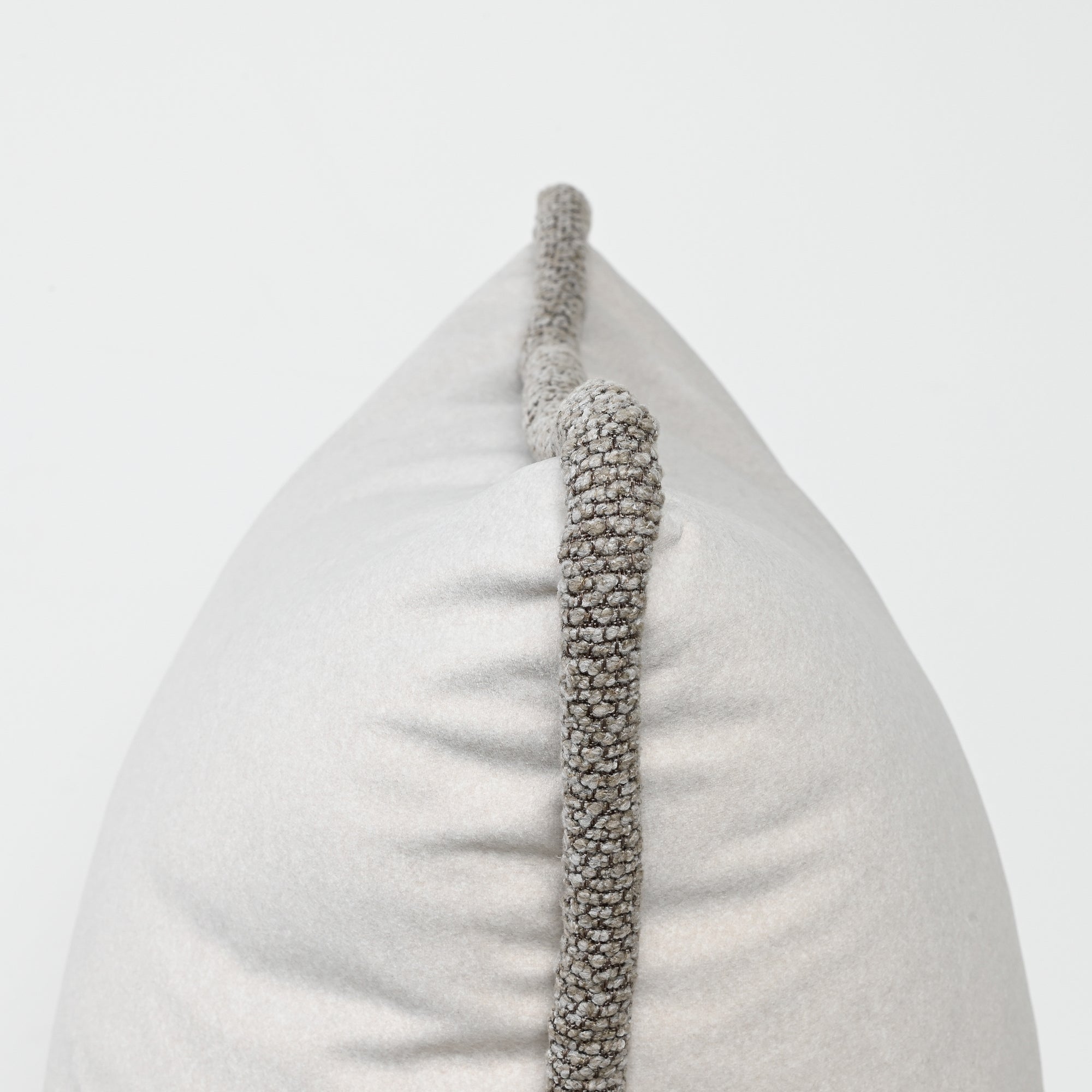 Decorative pillow with textured gray border on a light gray background