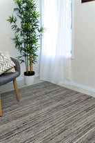 This image highlights the detailed grooved pattern and high-low finish of the rug, showcasing the luxurious texture and subtle tonal variations in the American Walnut colour.