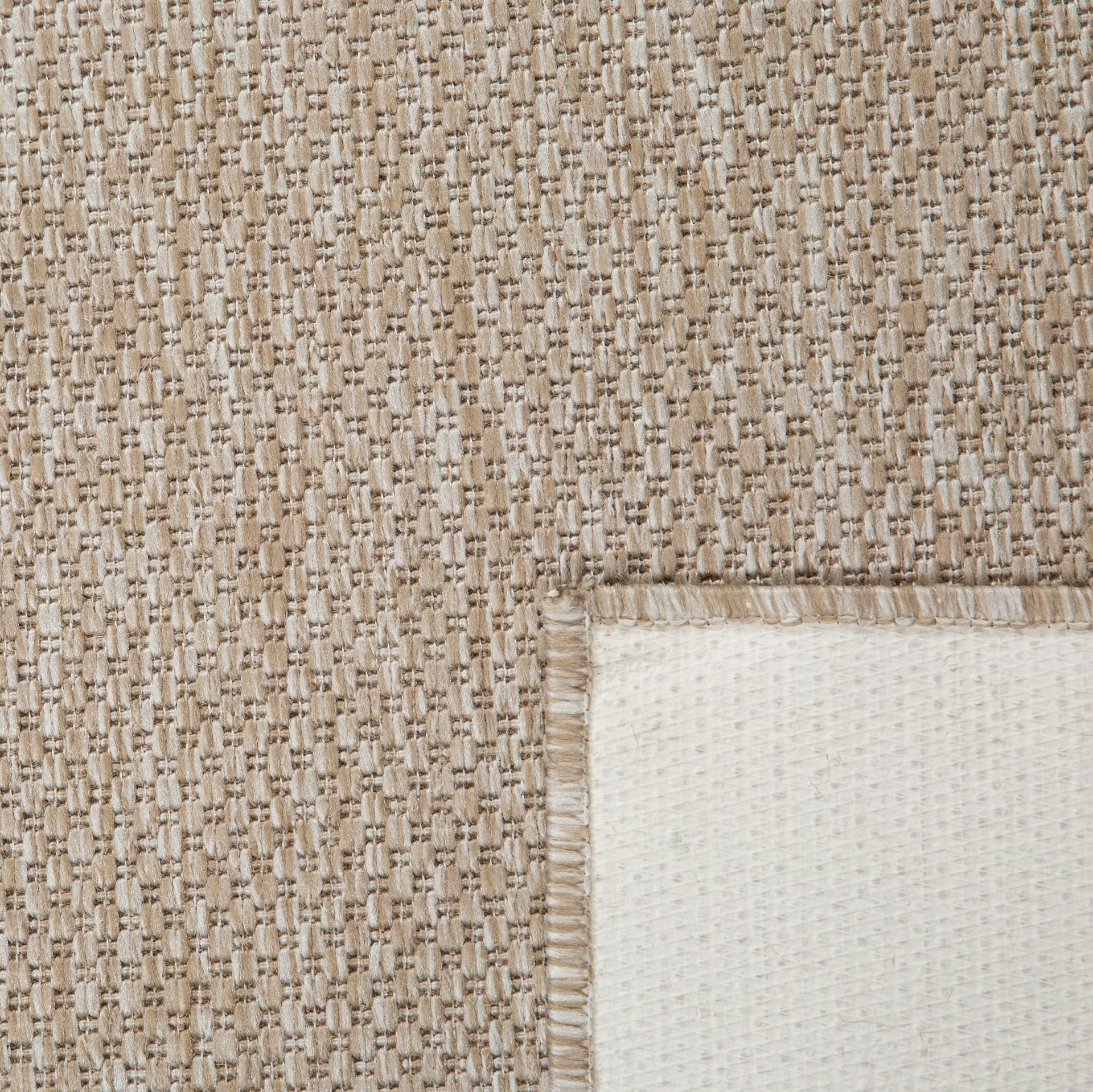 The latex backing of the chino sand rug o