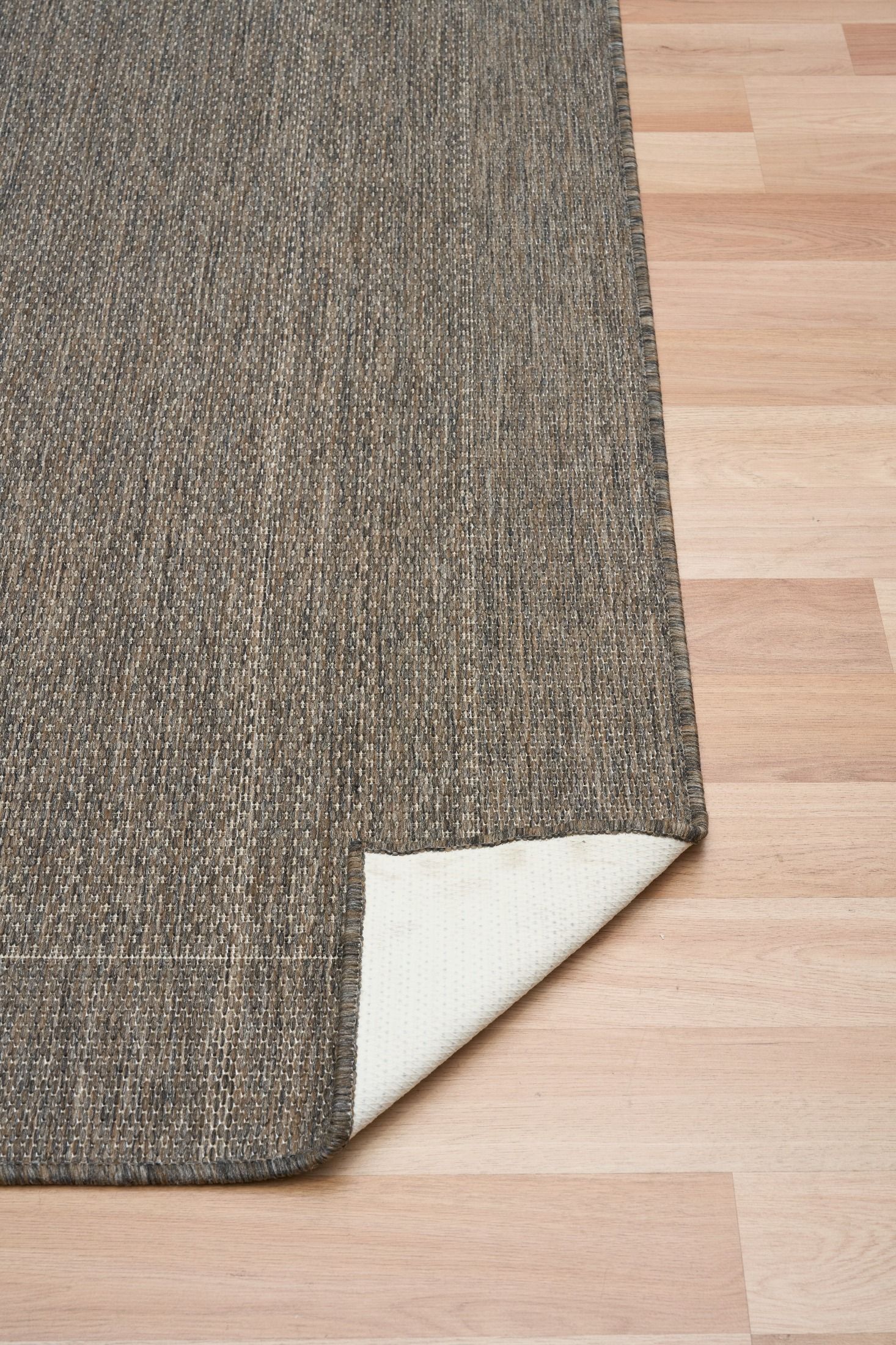 Chino rug showing its latex backing on a timber floor